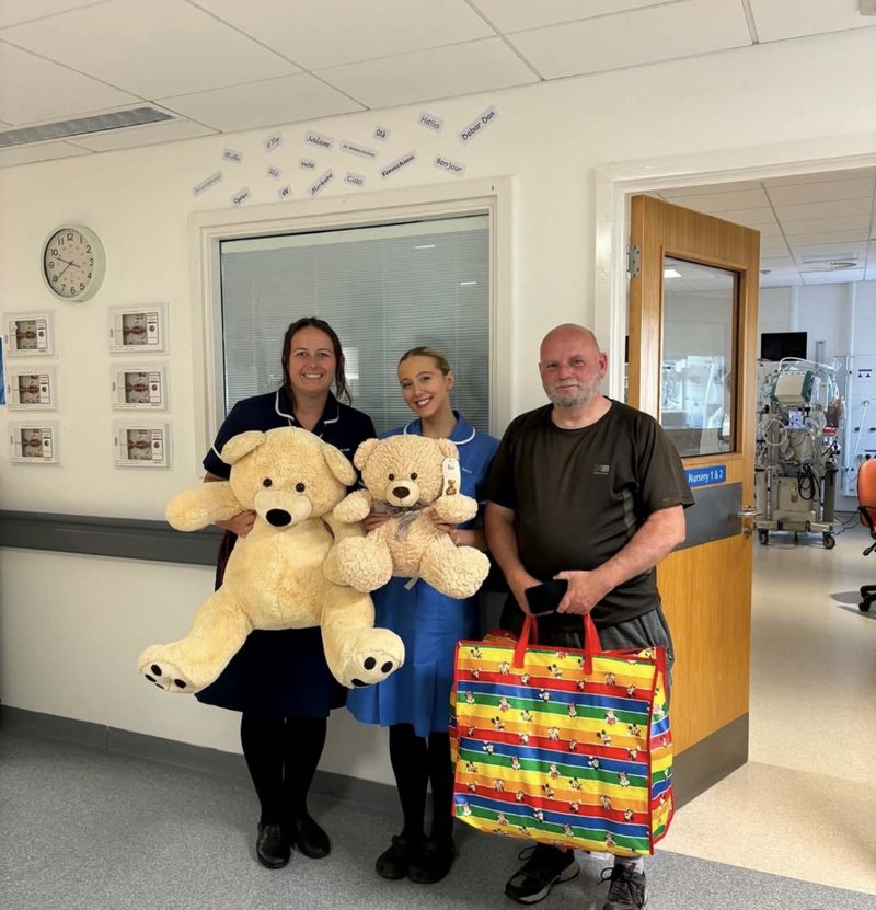 Jim with two neonatal nurses holding teddy bears at NICU Blackpool.